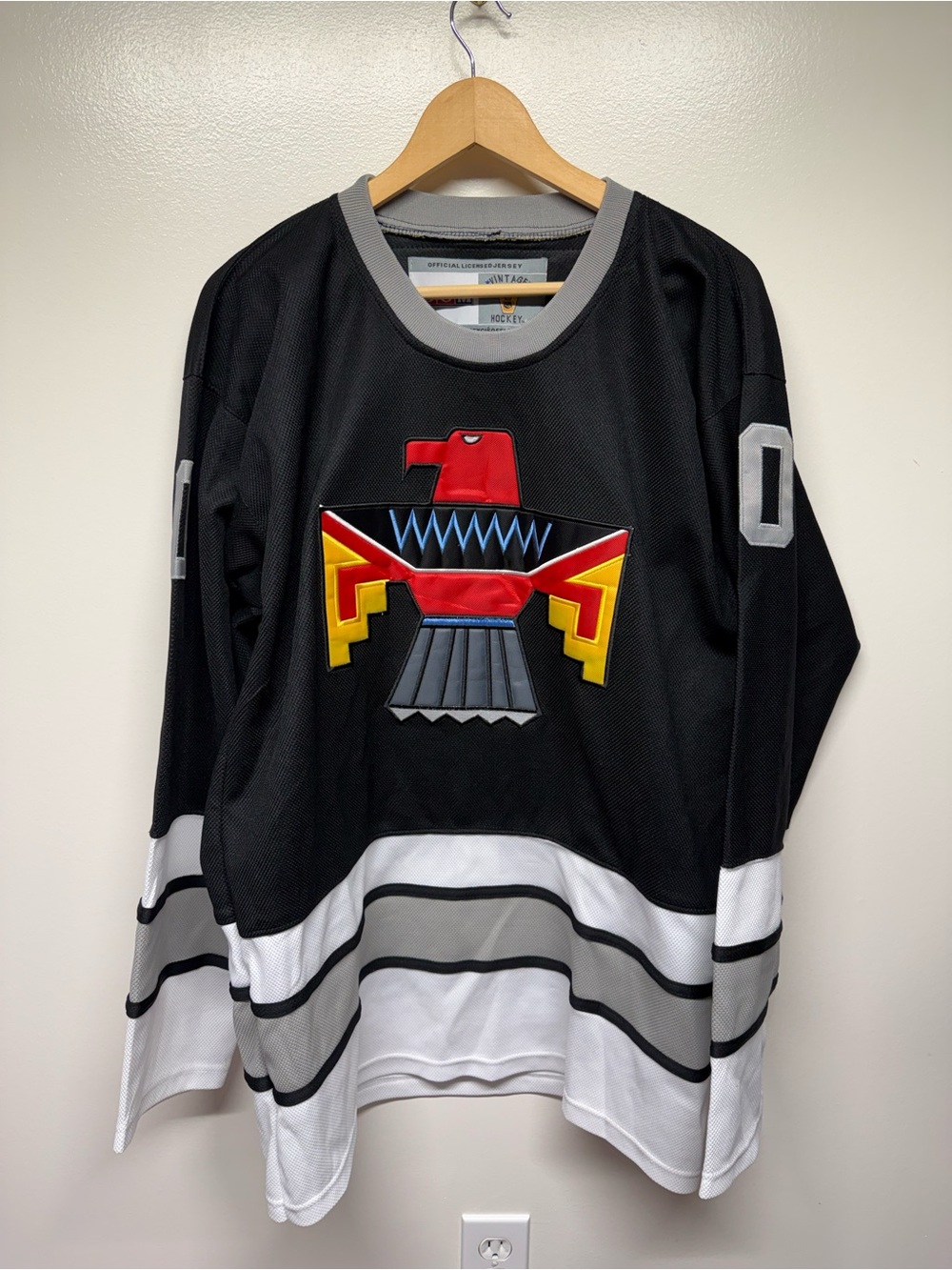 CCM Black, White and Gray Hockey Jersey with Colorful Thunderbird Patch